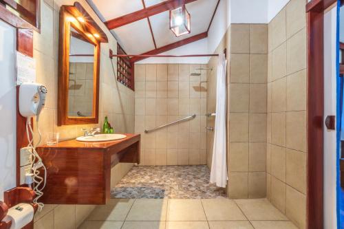 a bathroom with a sink and a shower at Namuwoki Lodge in Puerto Viejo