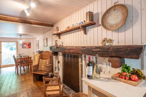 a kitchen and dining room with a counter and a table at Spitzenhaus Val Onsernone - Happy Rentals in Vergeletto