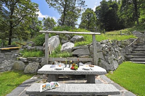 a picnic table with food on it in a garden at Rustico Alla Bolla - Happy Rentals in Frasco