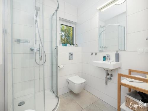 a bathroom with a shower and a toilet and a sink at Studio in Niechorze near Baltic Beach in Niechorze