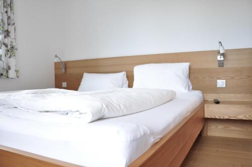 a bedroom with two beds with white sheets at Ölerhof in Haag am Hausruck