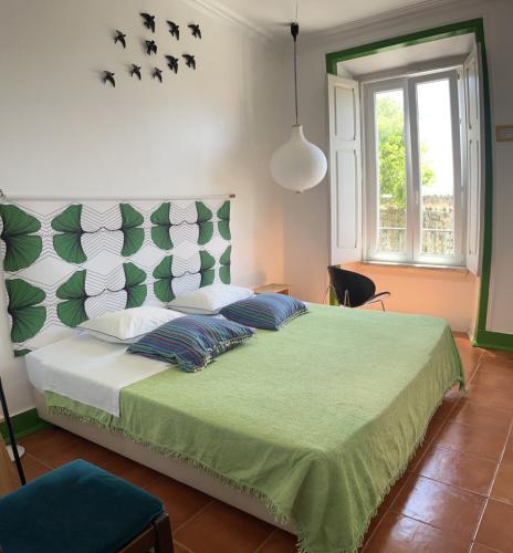 a bedroom with a large bed with two pillows at Peniche Hostel in Peniche