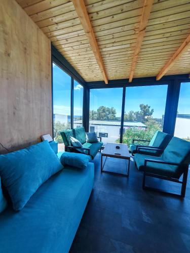 a living room with a large blue couch and chairs at Sea view Anika by Vellaris, Luxury Mobile Home in Mali Lošinj