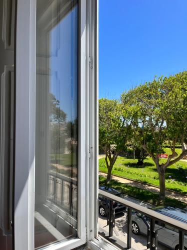 an open window with a view of a park at Peniche Hostel in Peniche