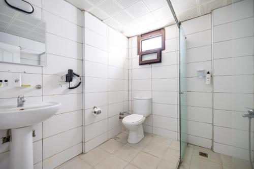 a bathroom with a toilet and a sink at MaxSea Beach Hotel in Bodrum City