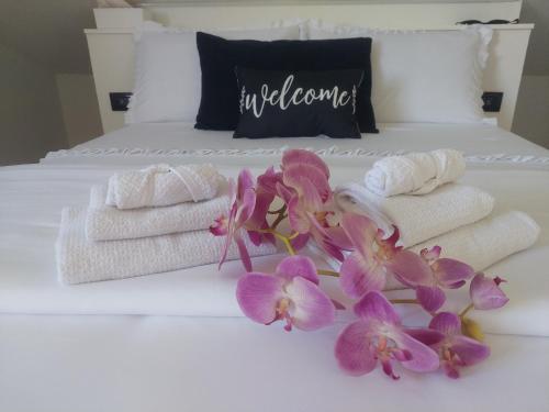 a white bed with towels and flowers on it at Oasi Relax in Borgo Isonzo