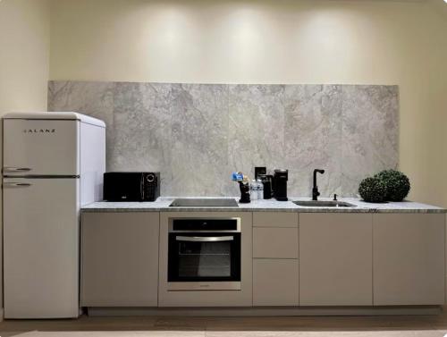 a kitchen with a white refrigerator and a sink at Free Parking 2 Bedroom The Comfy Haven in Pittsburgh