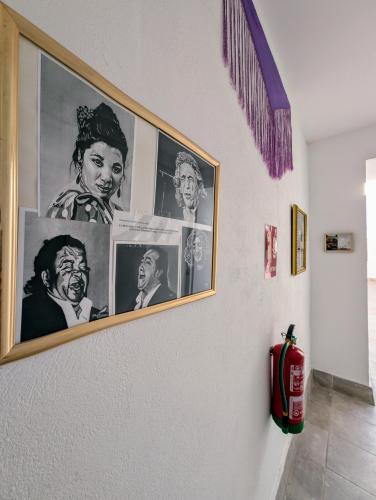 a wall with pictures offamousfamous people on it at A Jerez Apartamentos in Jerez de la Frontera