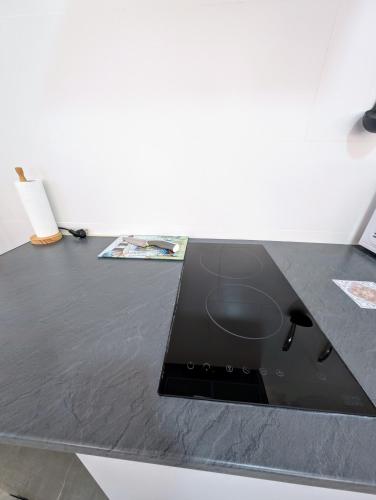 a black counter top with a laptop on it at A Jerez Apartamentos in Jerez de la Frontera