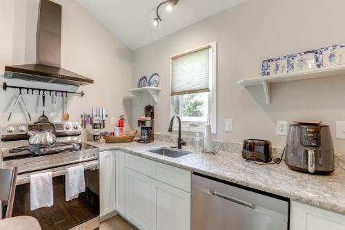 a kitchen with white cabinets and a sink at 1 Mi to Conway Riverwalk Studio in Historic Dtwn in Conway