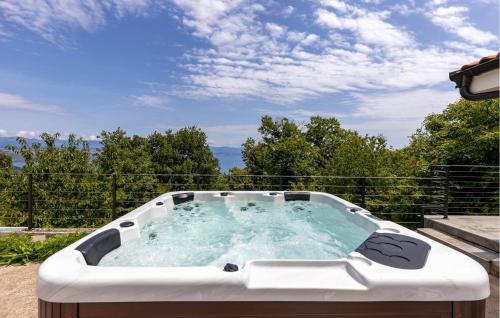 a jacuzzi tub sitting on a patio at Beautiful Home In Dobrec With Kitchen in Dobreć