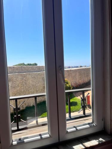 an open window with a view of a balcony at Peniche Hostel in Peniche