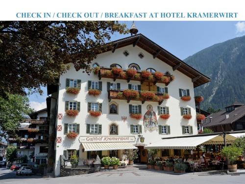 a large white building with flower boxes on it at Försterhaus & Haus Andrea in Mayrhofen