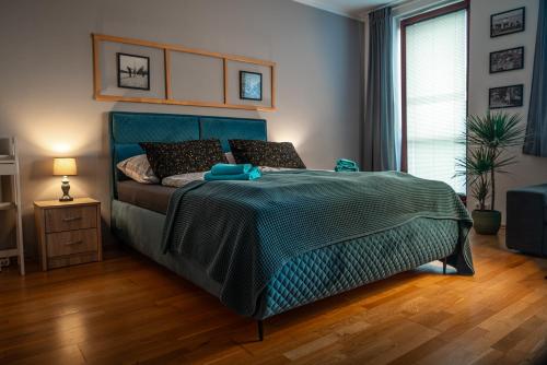 a bedroom with a bed with a green comforter at Apartment Čeladná in Čeladná