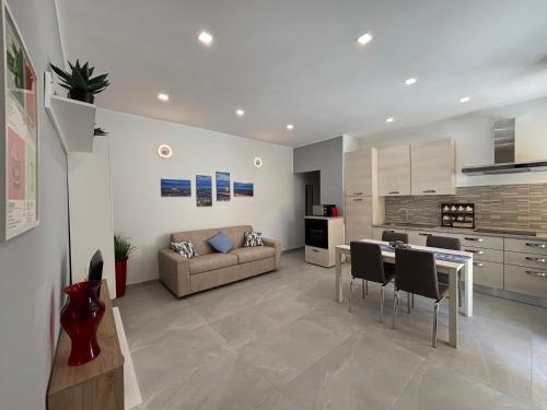 a kitchen and living room with a couch and a table at Sweet House in Collegno