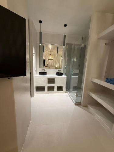 a white bathroom with a sink and a mirror at Value for money Naousa Center designer spacious room in Naousa