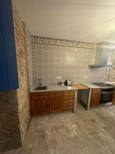 a kitchen with a sink and a counter top at Casa Santiago in Ézaro