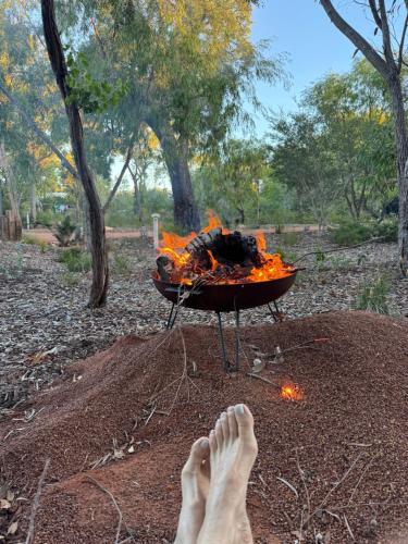 a person standing in front of a fire grill at Unique Australian Shed Style House in Dunsborough