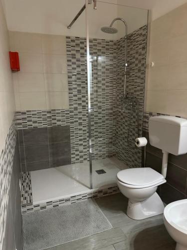 a bathroom with a shower with a toilet and a sink at Affittacamere Gess in Montalto Uffugo