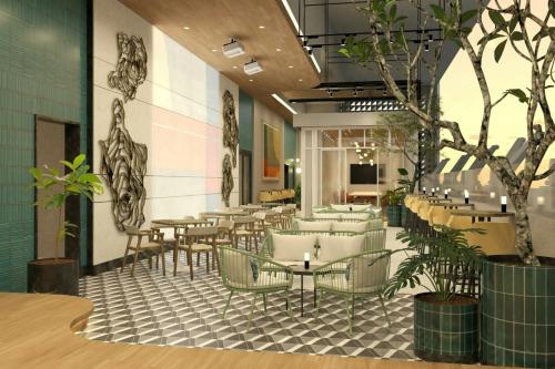 a restaurant with tables and chairs and plants at The Westin Manila in Manila