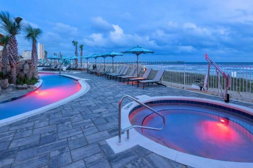 a swimming pool with the beach in the background at SpringHill Suites by Marriott Panama City Beach Beachfront in Panama City Beach
