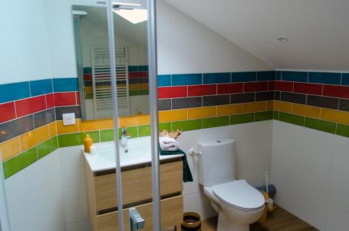 a bathroom with a toilet and a sink at Chambre familiale Odile et les cycleux in Docelles