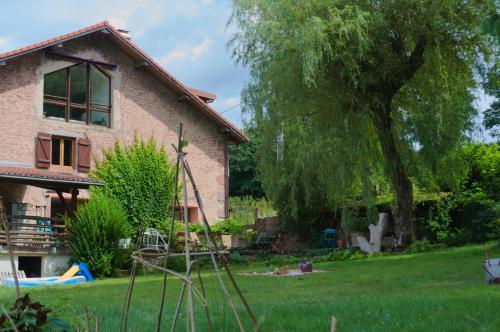 a yard with a house and a tree at Chambre familiale Odile et les cycleux in Docelles