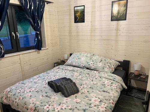 a bedroom with a bed with a floral comforter at Rajskie Wzgórze in Rajcza