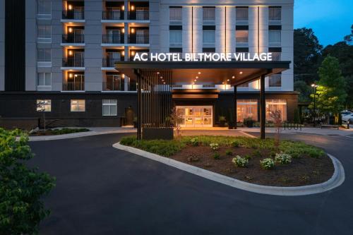 a hotel building with a sign that reads ac hotel bathroom village at AC Hotel Asheville Biltmore Village in Asheville