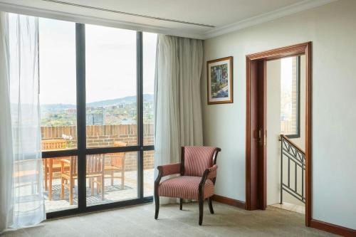 a room with a chair and a balcony at JW Marriott Caracas in Caracas