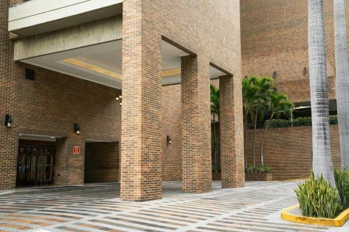 a brick building with three brick pillars in a courtyard at JW Marriott Caracas in Caracas