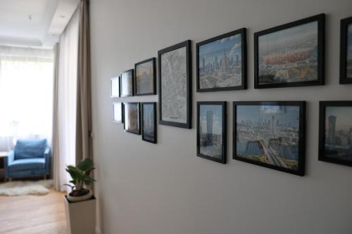 a bunch of pictures hanging on a wall at Awangarda in Warsaw