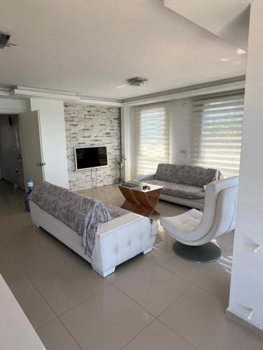 a living room with two couches and a fireplace at Leamarin in Urla