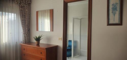 ein Spiegel neben einer Kommode in einem Zimmer in der Unterkunft Edificio Zoqueiro in San Cosme de Barreiros