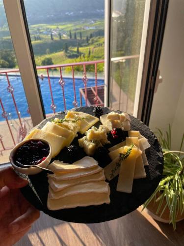 a plate of cheese and other foods on a table at Golden Mirror in Lamego