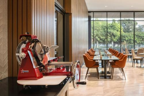 a red machine on a table in a restaurant at AC Hotel by Marriott Santiago de los Caballeros in Santiago de los Caballeros
