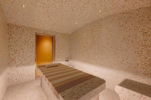 a room with a bed in the corner of a room at JW Marriott Marquis City Center Doha in Doha