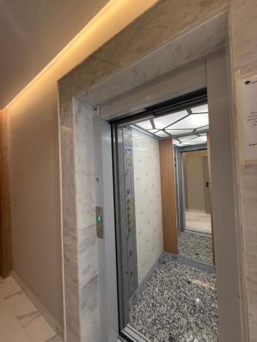 a glass door in a room with a hallway at trqnche 5 imm k rsd no 189 riad essalam in Tangier