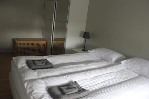 a bedroom with two beds with towels on them at Vesturkot horse farm Guesthouse in Selfoss