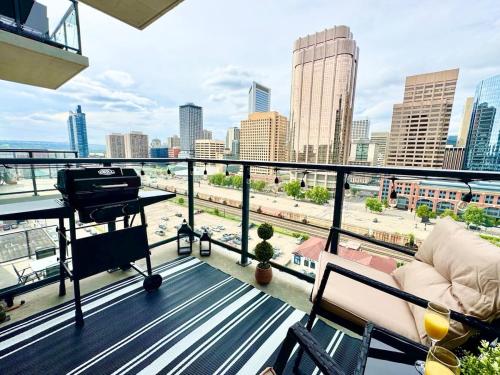 a balcony with a view of a city skyline at Elegant, Comfy & Sophisticated MetroLux Downtown Suite in Calgary