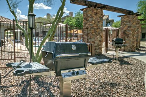 a barbecue grill in a park with a fence at Raintree at Phoenix South Mountain Preserve in Phoenix