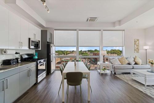 a kitchen and living room with a table and a couch at 2BR City Loft Sweeping Glass Views in Chicago