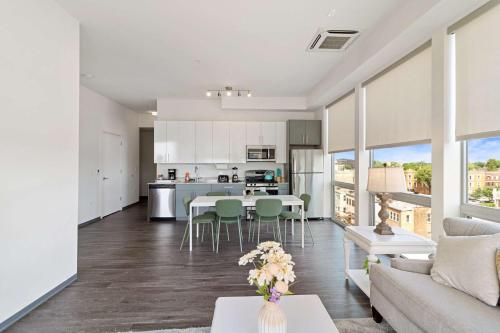 a kitchen and living room with a table and chairs at 2BR City Loft Sweeping Glass Views in Chicago