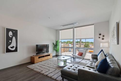 a living room with a couch and a television at New Modern 1BR Lux City Escape in Chicago