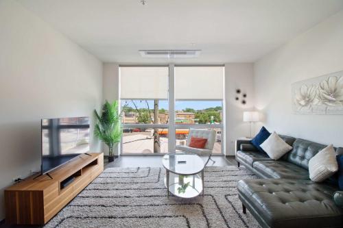 a living room with a couch and a television at New Modern 1BR Lux City Escape in Chicago