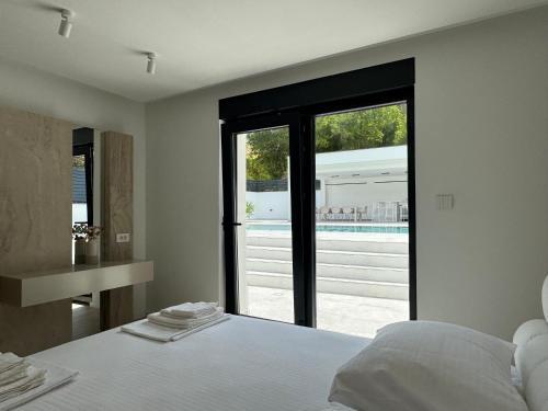 a bedroom with a bed and a view of a pool at Villa Naléj in Mostar