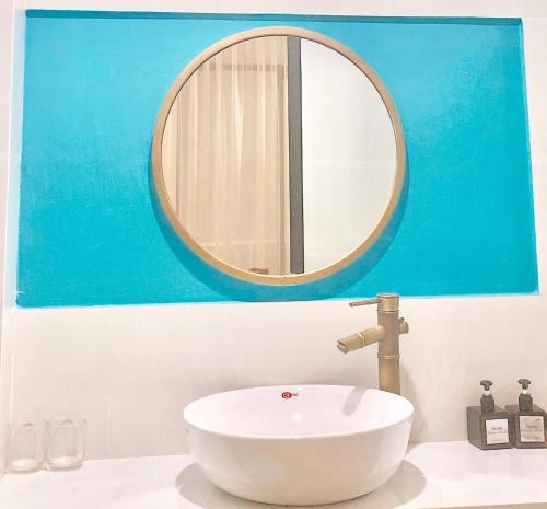 a bathroom with a white sink and a mirror at The Chill in Hue