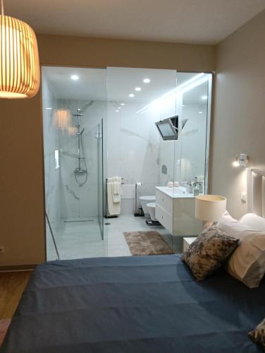 a bedroom with a large glass shower and a bed at Villa Amazing View Funchal - Lux & Pool in Funchal
