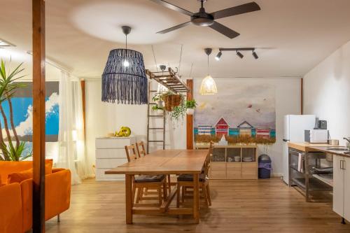 a kitchen and dining room with a wooden table at MP Beach Club in Tootgarook