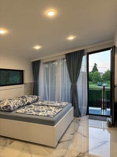 a bedroom with a bed and a large window at Hotel Edelweiss in Ureki